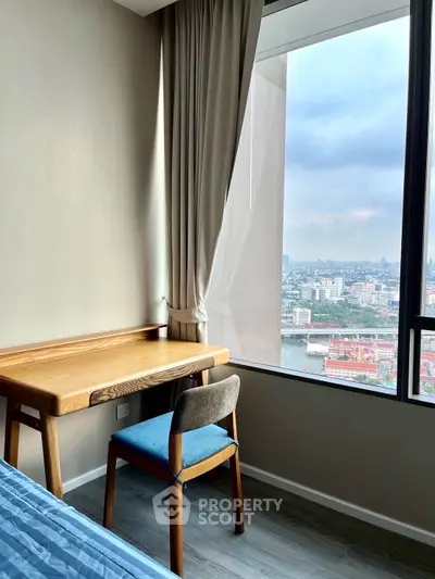 Modern bedroom with city view and stylish wooden desk by the window