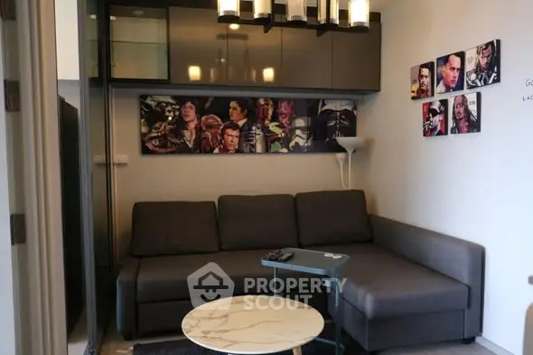 Stylish living room with modern gray sofa and chic wall art