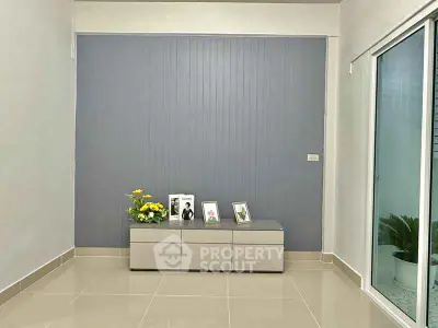 Minimalist interior with sleek cabinet and sliding glass door, perfect for modern living.