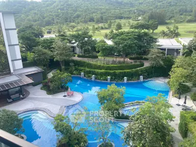 Luxurious resort-style pool with lush greenery and scenic views, perfect for relaxation and leisure.