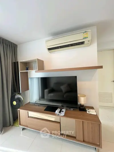 Modern living room with sleek TV unit and air conditioning