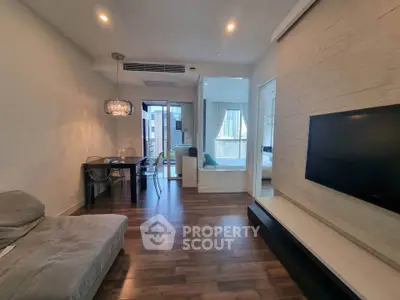 Modern living room with sleek design, hardwood floors, and large windows offering city views.