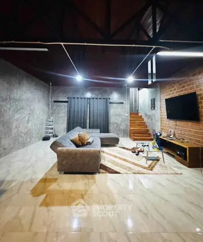 Spacious modern living room with stylish decor and cozy seating area.