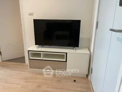 Modern living room with sleek TV stand and flat-screen TV, perfect for cozy entertainment.