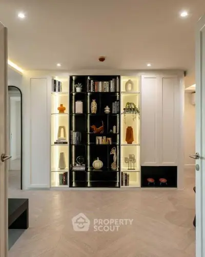 Elegant modern living room with stylish built-in shelving and ambient lighting.
