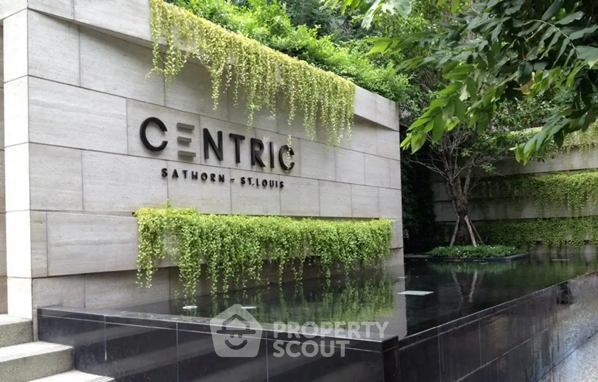 Modern building entrance with lush greenery and sleek design