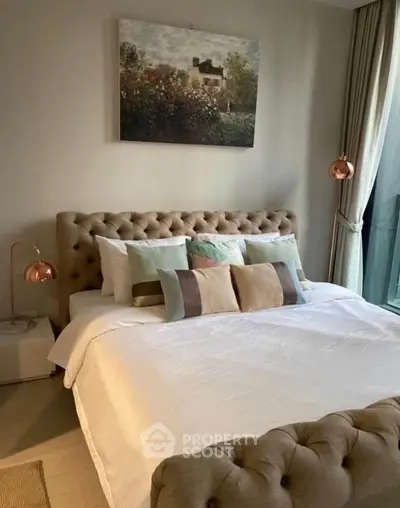 Luxurious bedroom with elegant decor and plush bedding in modern apartment.