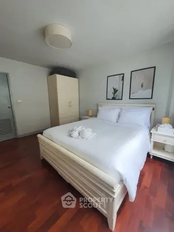 Cozy bedroom with wooden flooring and elegant decor