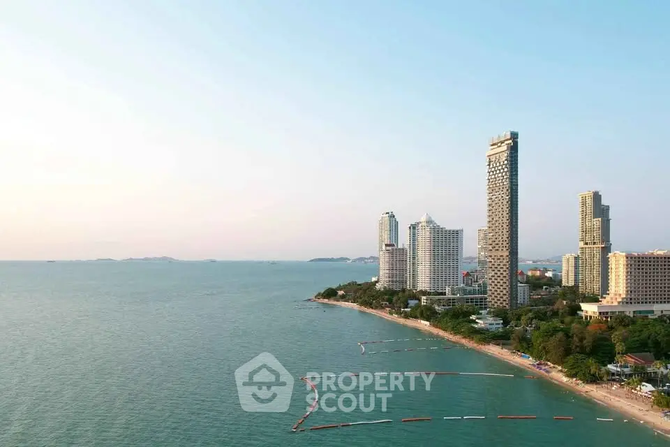 Stunning beachfront skyline with modern high-rise buildings and serene ocean view.