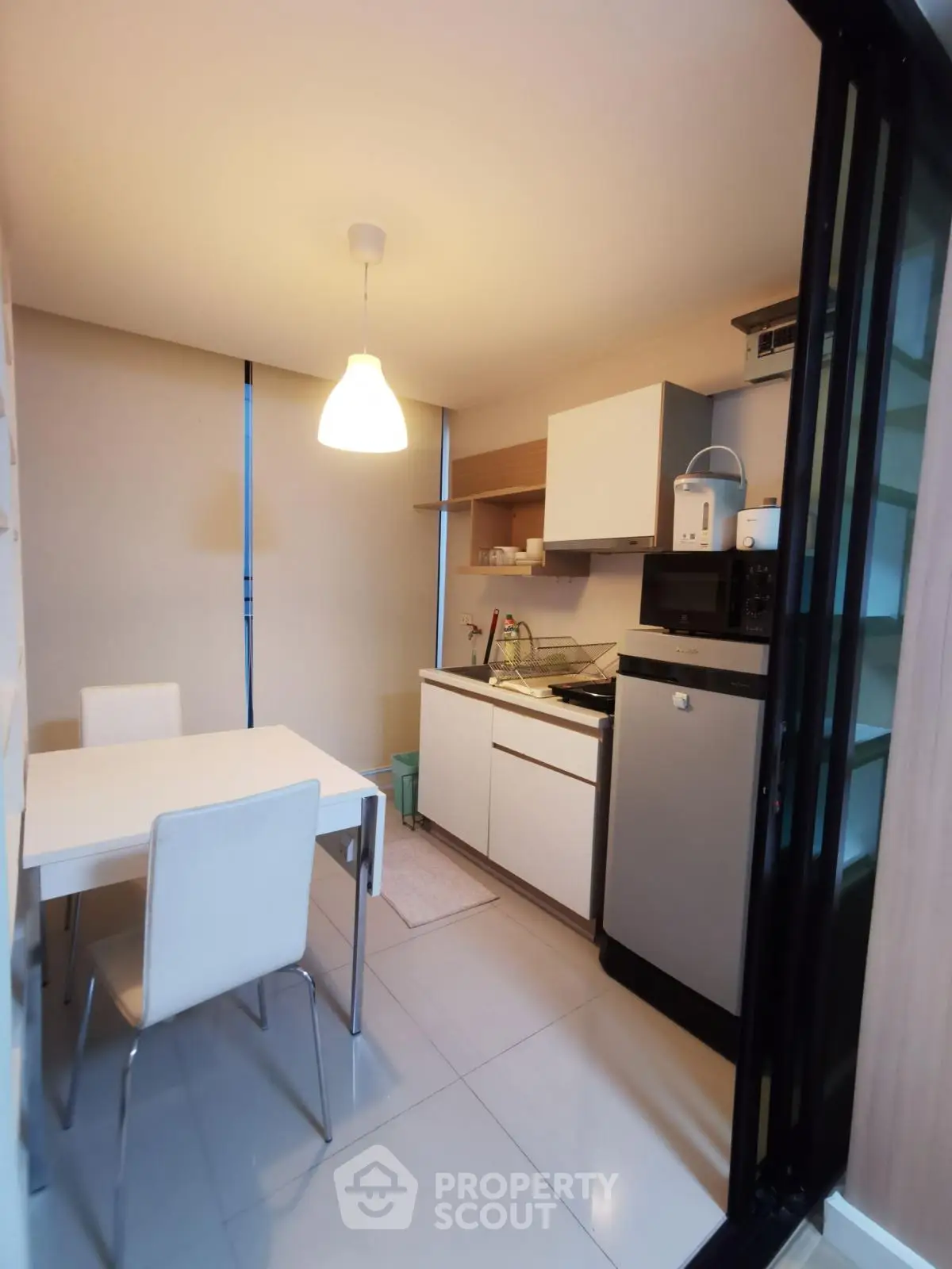 Modern compact kitchen with dining area and sleek appliances