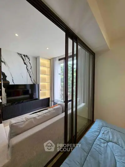 Modern living room with stylish decor and large windows offering natural light and a cozy ambiance.