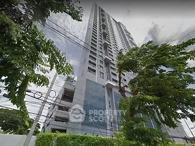 Stunning high-rise building with modern architecture and lush greenery in urban setting.