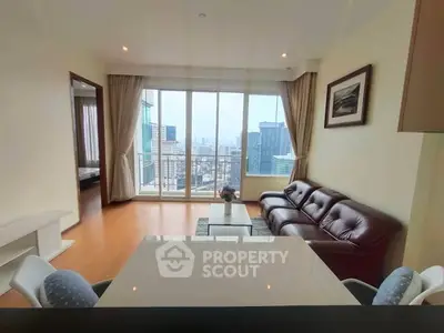 Spacious living room with city view and elegant furnishings in modern apartment.