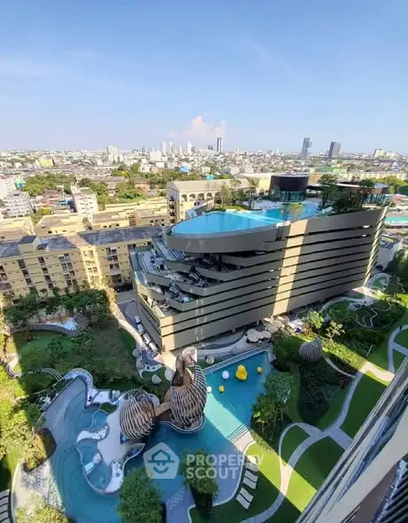 Stunning aerial view of modern building with rooftop pool and lush garden in urban setting.