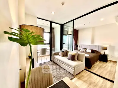 Modern studio apartment with open layout, featuring cozy living area and stylish bedroom.