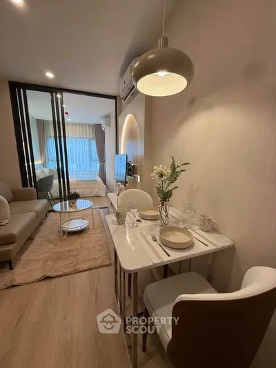 Modern living room with dining area, cozy seating, and stylish decor in a contemporary apartment.