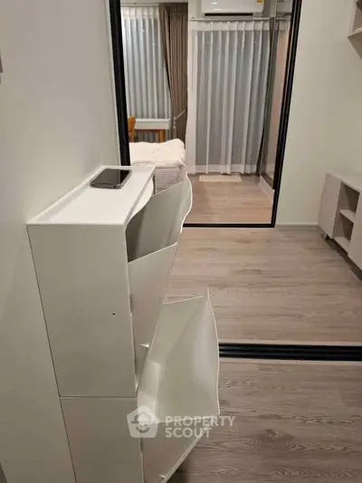 Modern bedroom with sleek storage and mirrored sliding doors