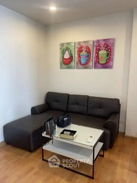 Cozy living room with modern sofa and colorful wall art, perfect for relaxation.