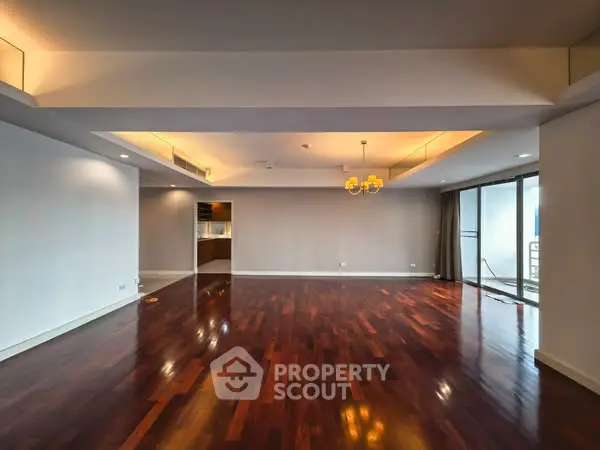 Spacious modern living room with hardwood floors and elegant lighting