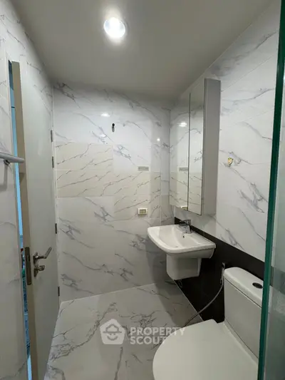 Modern bathroom with marble tiles and sleek fixtures