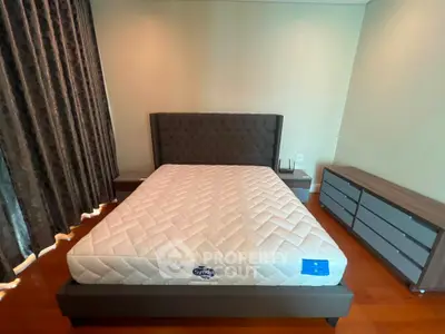 Modern bedroom with stylish bed and elegant furniture, featuring a cozy ambiance and sleek design.