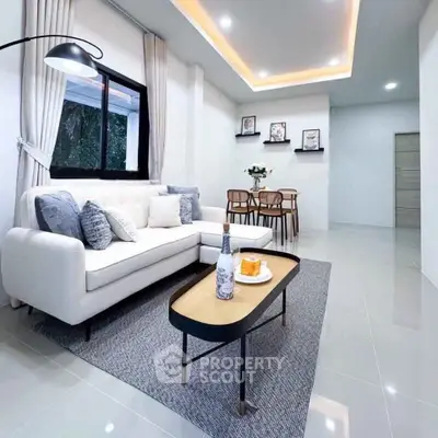 Modern living room with stylish decor and cozy seating area, perfect for relaxation and entertaining.