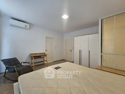 Spacious bedroom with modern furniture and air conditioning, perfect for comfort and relaxation.