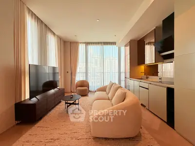 Luxurious modern living room with plush sofa and sleek kitchen, floor-to-ceiling windows.