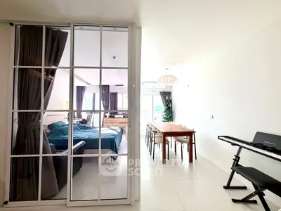 Spacious modern apartment with open living and dining area, featuring a cozy bedroom and stylish decor.