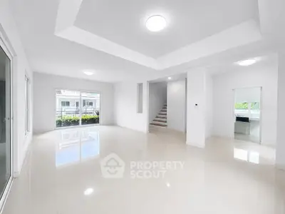 Spacious modern living room with glossy floors and large windows