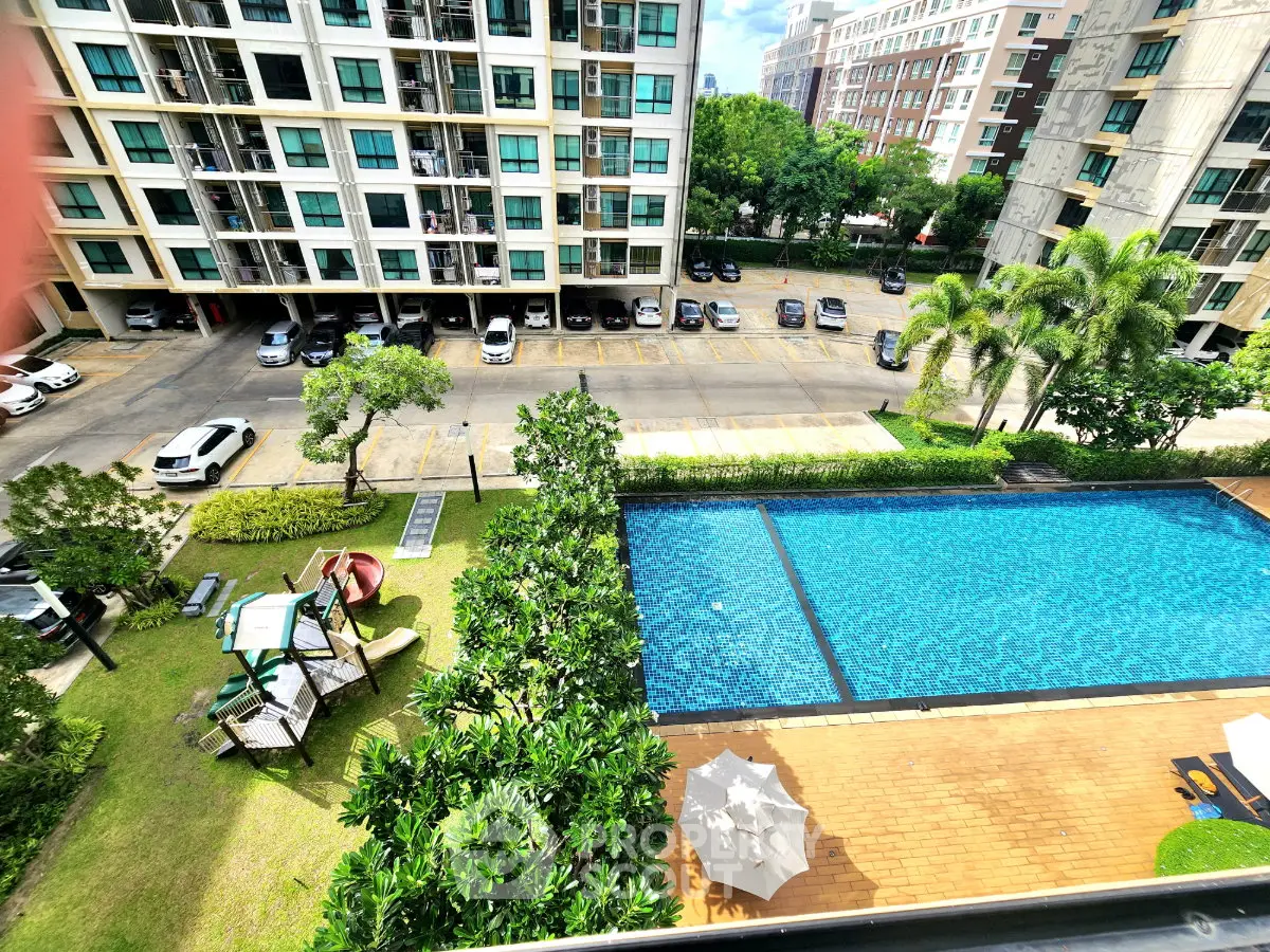 Stunning apartment view with pool, playground, and lush greenery in a modern residential complex.
