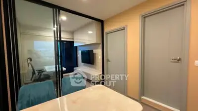 Modern interior with glass partition and sleek furniture in a stylish apartment.
