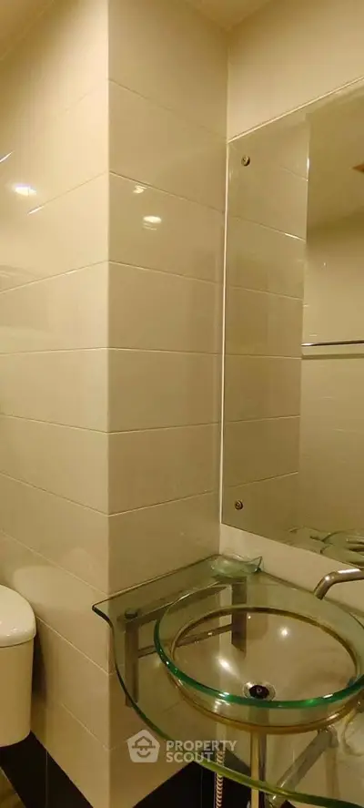 Modern bathroom with glass sink and sleek tile design