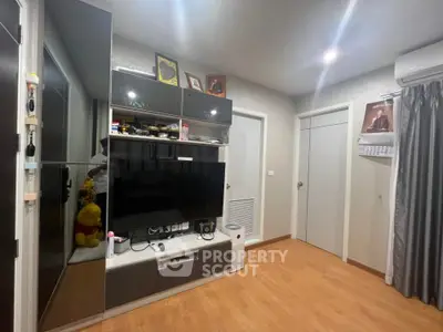 Modern living room with sleek entertainment center and wooden flooring
