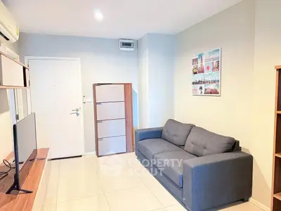 Modern living room with sleek furniture and stylish decor in a cozy apartment.