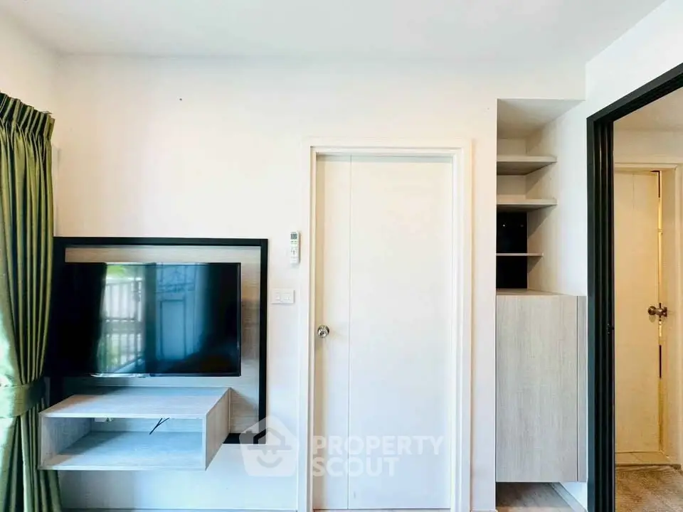Modern living room with wall-mounted TV and sleek storage solutions