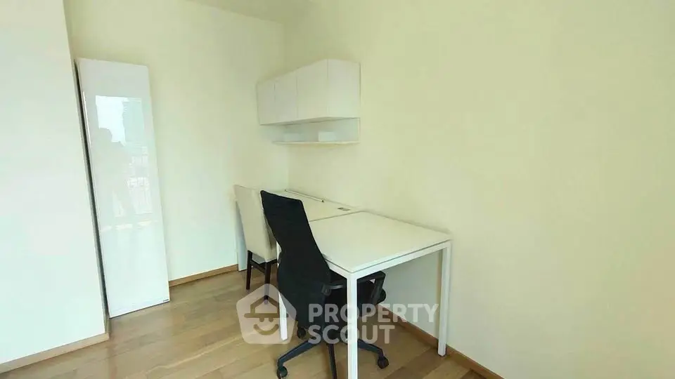 Modern study room with sleek desk and chairs, ideal for productivity.