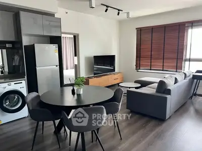 Modern living room with sleek furniture and open kitchen layout