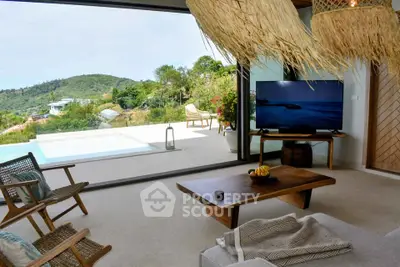 Luxurious living room with stunning view of infinity pool and lush greenery