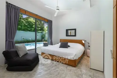 Luxurious bedroom with pool view, modern decor, and natural light.