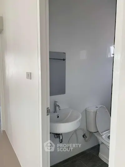 Compact bathroom with modern fixtures and minimalist design, perfect for small spaces.