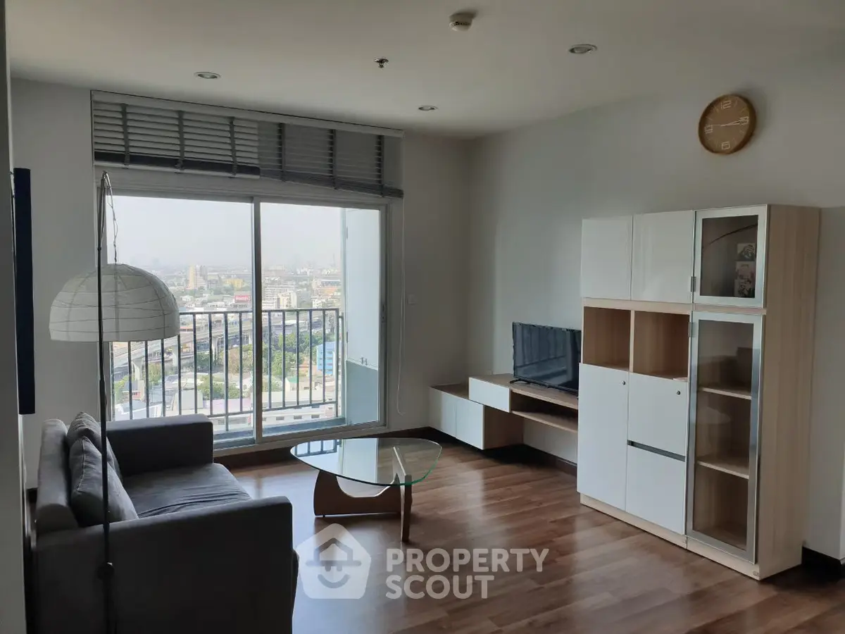 Modern living room with city view, sleek furniture, and natural light.