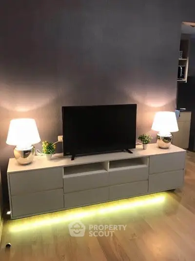 Modern living room with sleek TV stand and ambient lighting