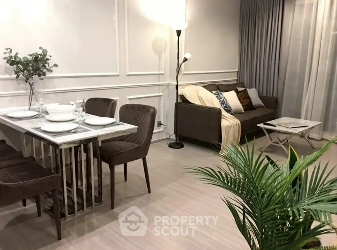 Stylish modern living room with elegant dining area and cozy sofa.