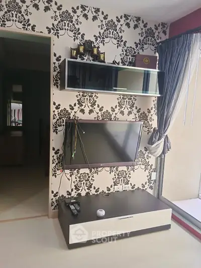 Stylish living room with modern TV setup and elegant wallpaper design