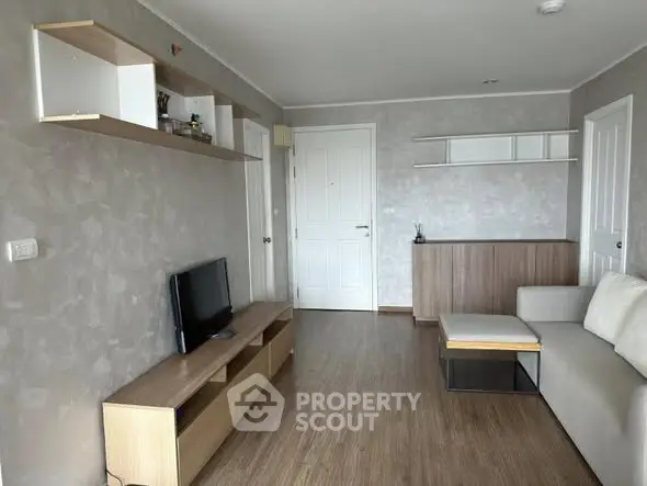 Modern living room with sleek wooden flooring and minimalist furniture design.