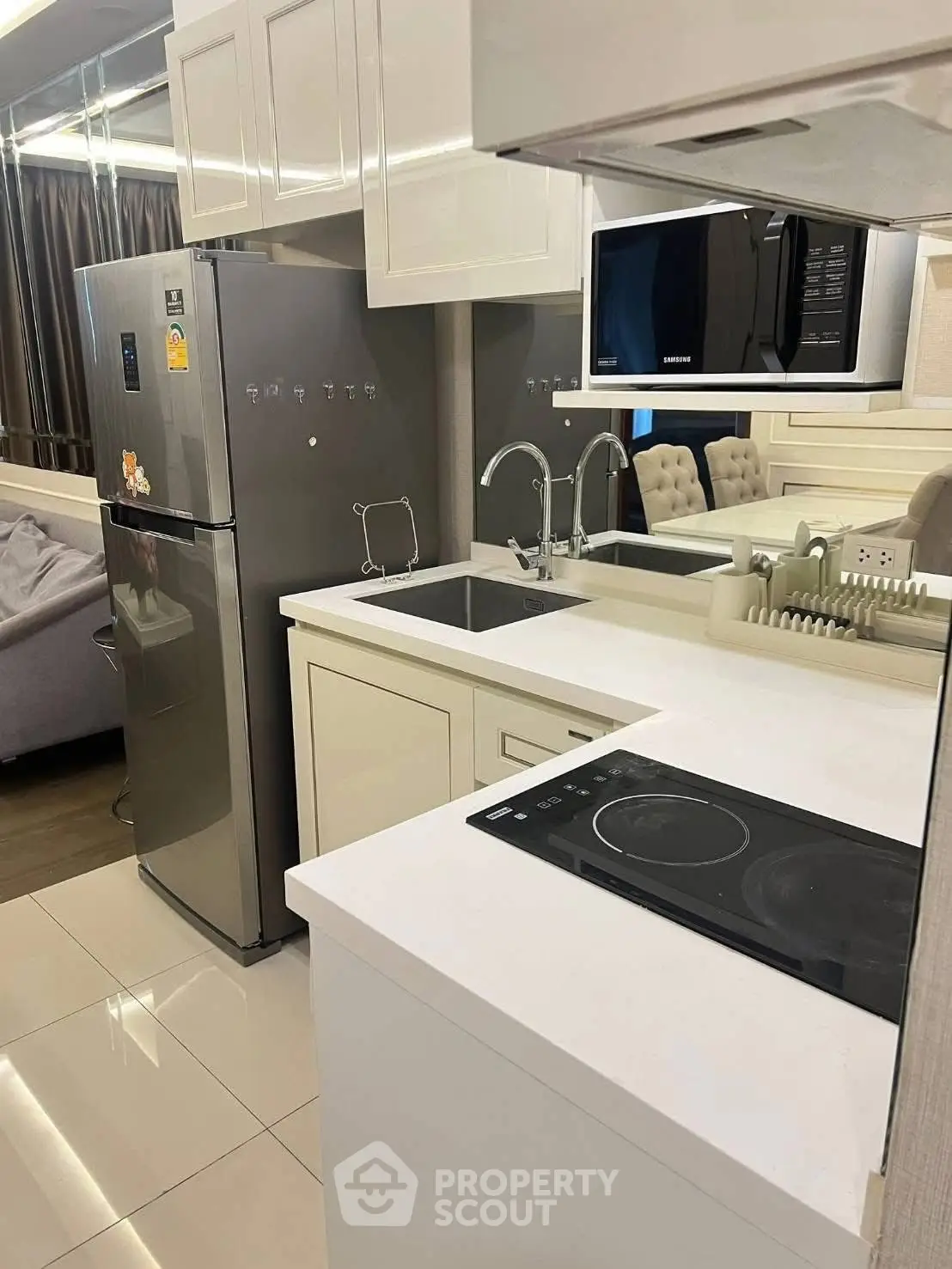 Modern kitchen with sleek appliances and elegant cabinetry in a stylish apartment.