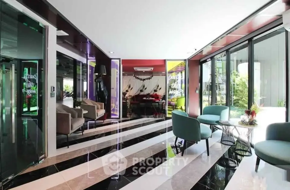 Modern lobby with stylish seating and vibrant decor in a contemporary building.