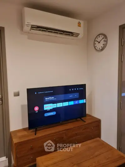 Modern living room with air conditioning and smart TV setup