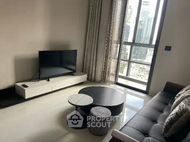 Modern living room with sleek furniture and city view from large window